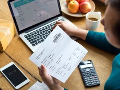 femme avec ordinateur et facture